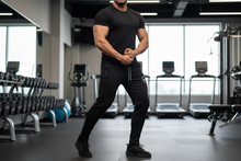 Load image into Gallery viewer, Male model in gym wearing Evolution Joggers
